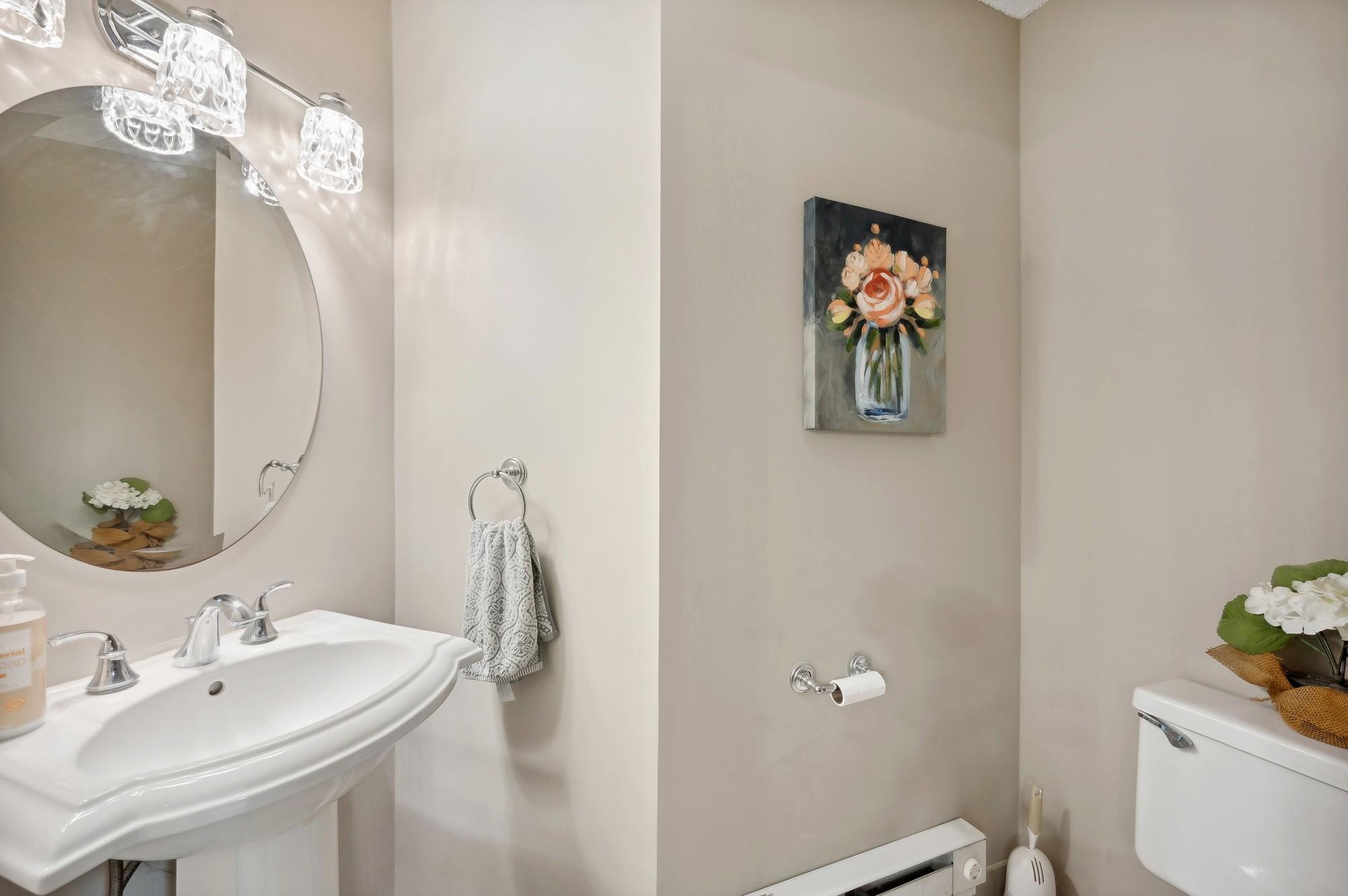 Main floor powder room with updated fixtures and lighting.