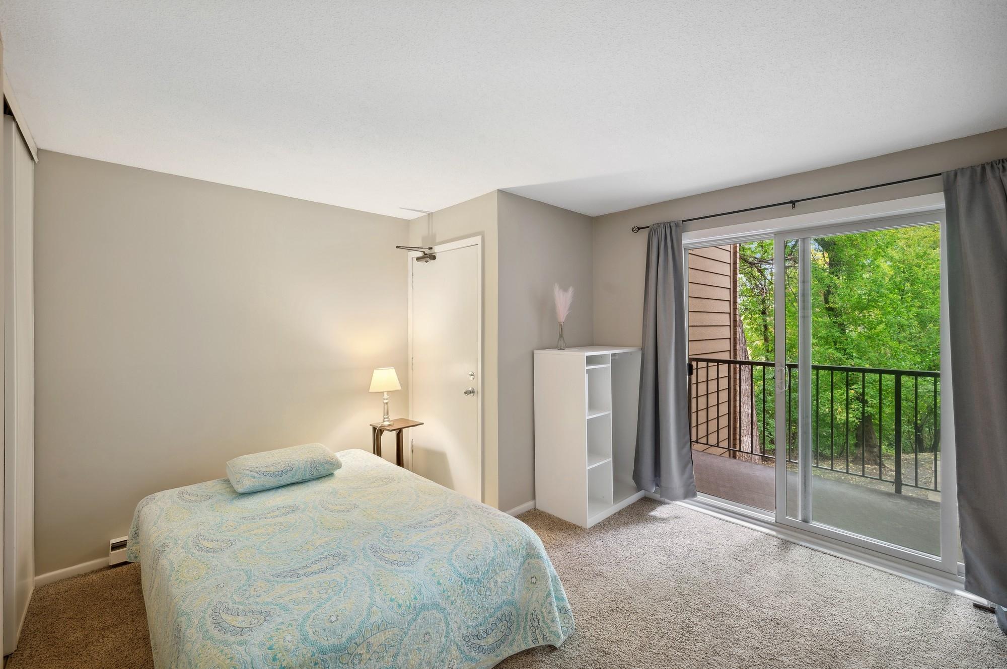 Door in secondary bedroom leads to a stairway and secure entrance for easier furniture moving.