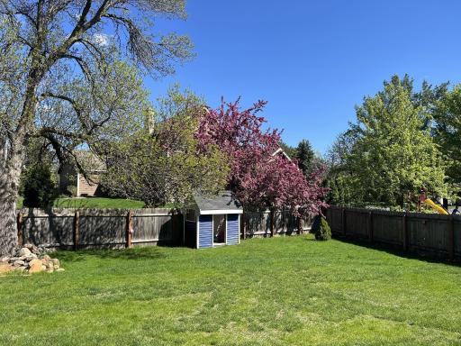 Fenced yard. Sweet shed/playhouse included