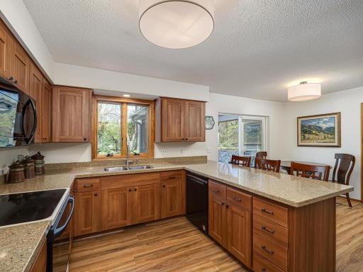 Large breakfast bar eat-in with ample cabinetry and a wall of cabinets surrounding the refrigerator.