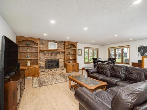 Spacious family room addition with luxury LVP flooring and open concept layout, complete with cozy gas fireplace and wet bar.