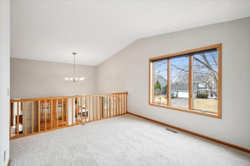 Upper level family room with vaulted ceilings and open view to the dining room