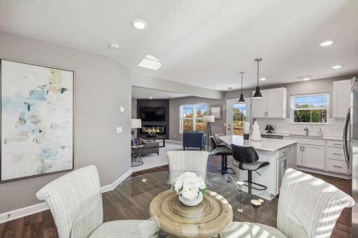 Photo for 21942 Primrose Path, Farmington, MN 55024 - Listing #6486300 Open, main level layout flowing from dining area to kitchen to family room. (Photo of decorated model, actual home's finishes may vary slightly)