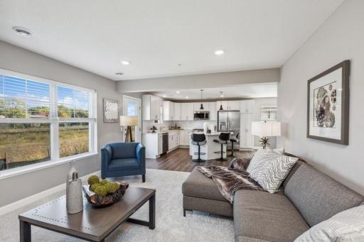 Photo for 21942 Primrose Path, Farmington, MN 55024 - Listing #6486300 Soaring windows provide an abundance of natural light to flow throughout the family room. (Photo of decorated model, actual home's finishes may vary slightly)