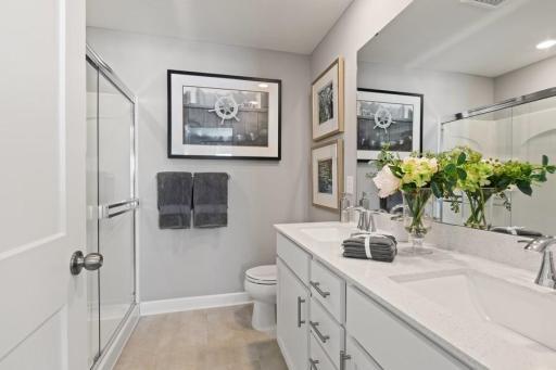 Photo for 21942 Primrose Path, Farmington, MN 55024 - Listing #6486300 Owner's bathroom with raised, double-sink vanity, five-foot walk-in shower, and a linen closet. (Photo of decorated model, actual home's finishes may vary slightly)