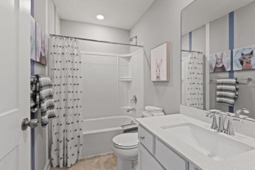 Full bathroom on the upper level shared by bedrooms #2 & 3. (Photo of decorated model, actual home's finishes may vary slightly)