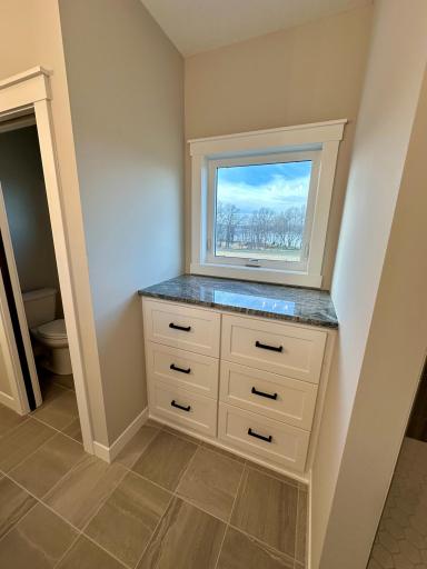 Primary Bath Storage w/ Granite Top & Lake View Window
