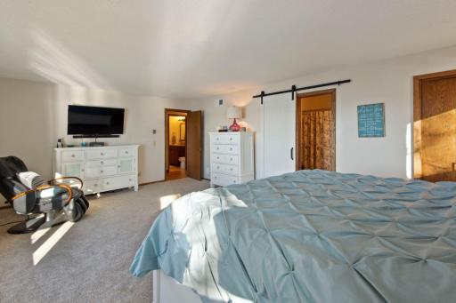 Huge upper level owner's suite with modern slider to 3/4 ensuite bathroom.
