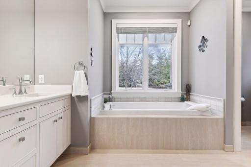 Main floor Primary bath suite with heated tile floors...