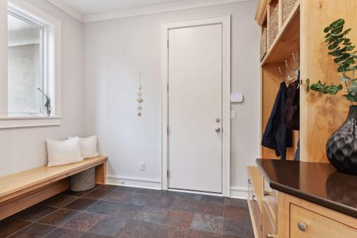 Main floor mudroom with a built in hook and bench system and a walk in closet not shown to the left.