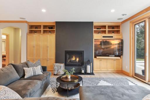 Beautiful natural built-in cabinetry for extra storage and a cozy gas fireplace.