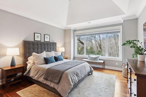 Main floor Primary Bedroom Suite with southern wooded views and overlooks the pool.