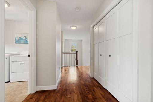 Second floor wide hallway with wall of storage