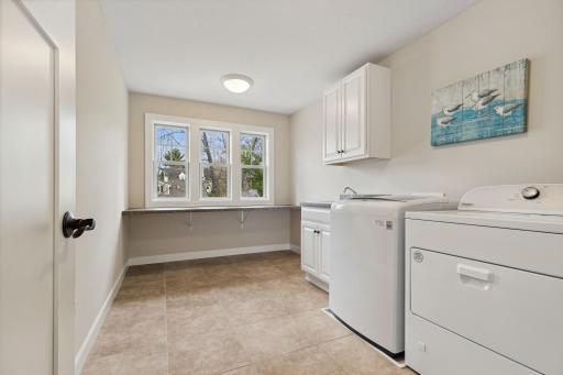 Large laundry room with storage and folding area