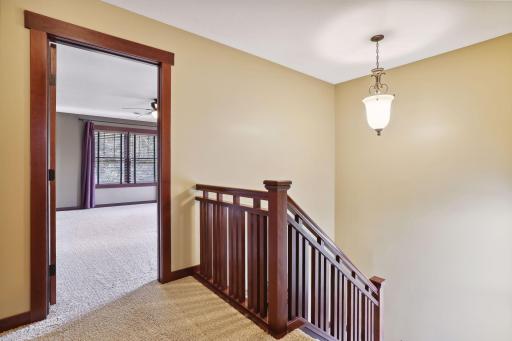 Open staircase with a beautifully crafted wooden design leading to the upper level.
