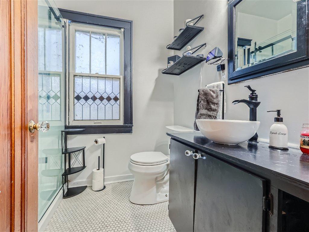 Nicely remodeled main floor bathroom. Lovely marble tiled floors & tiled shower - enjoy taking a shower w/ the rain shower head!