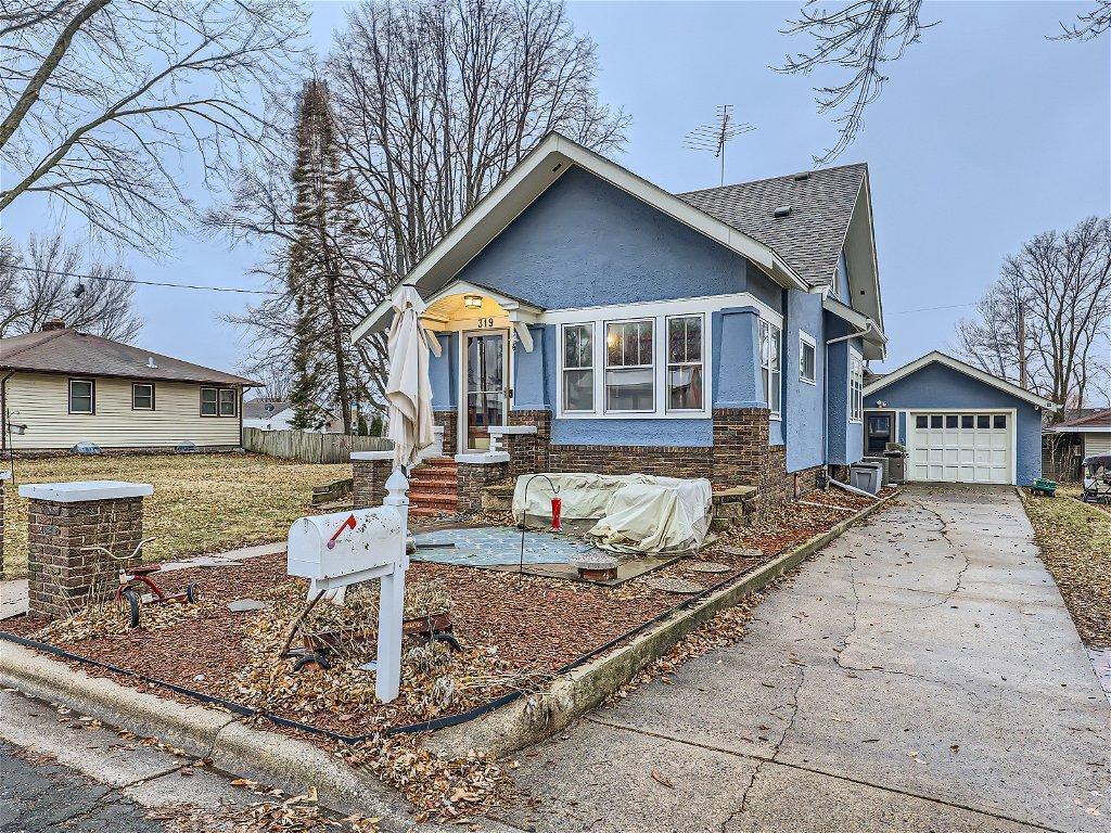 Enjoy the summer days on the front patio! Nice concrete driveway!