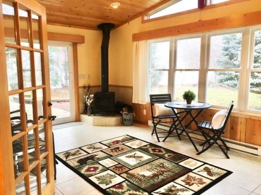 Photo for 5100 Camden Road, Baxter, MN 56425 - Listing #6487386 Four season porch for entertaining or watching the wildlife. You could set up a table here for your family meals. Wood burning stove is great for those chilly nights.