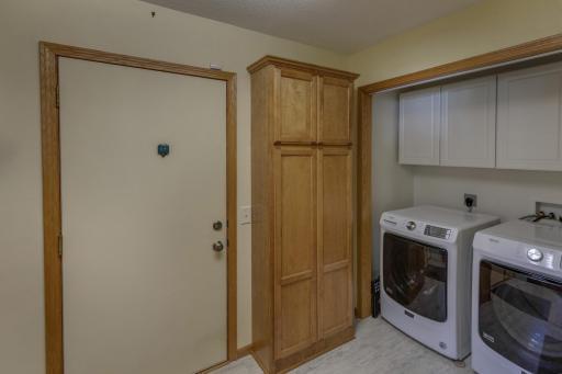 Photo for 5100 Camden Road, Baxter, MN 56425 - Listing #6487386 Laundry room provides lots of storage, a laundry sink and a newer front load washer and dryer. You will find the garage entrance in here right off the kitchen.