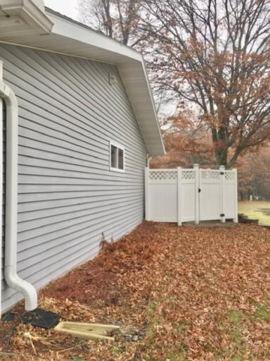 Photo for 5100 Camden Road, Baxter, MN 56425 - Listing #6487386 View of the side of the garage showing the privacy fence around the large patio in the backyard.
