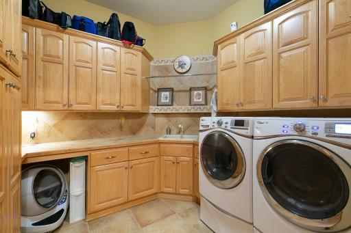 Main floor laundry with tons of storage space