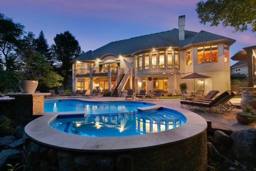 Stunning, resort style concrete pool w/hot tub, 3 waterfalls, vast deck/patio space + grilling deck w/gas line, stunning Pergola w/frplc & tons of space to entertain & relax.