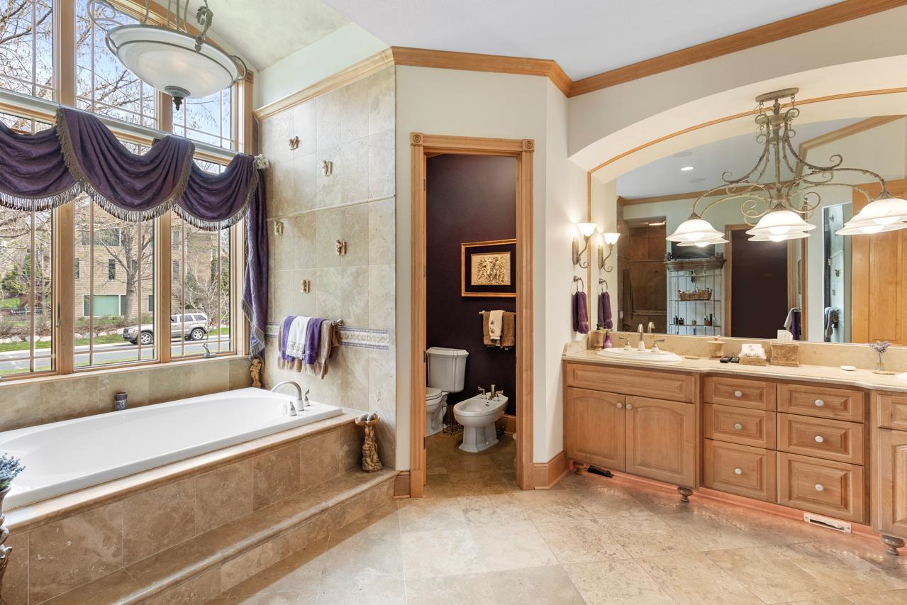 Private primary bathroom with relaxing tub and separate shower