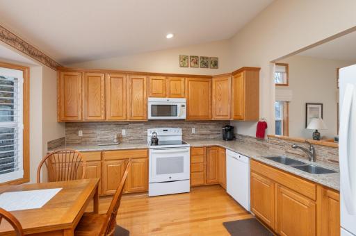Photo for 1255 Langewood Drive, Mound, MN 55364 - Listing #6487603 There is a vaulted ceiling here with recessed lighting, raised panel oak cabinetry and oak flooring. A pass through opens to the dining area.