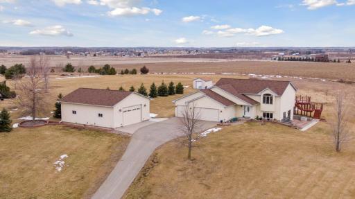 A breathtaking aerial view showcasing the long driveway leading to this magnificent home, complete with an additional garage for all your storage needs!