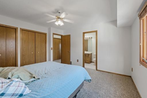 The primary bedroom offers TWO full size closets, a walk-through to the bathroom, a ceiling fan with a light, new carpet, and fresh paint.