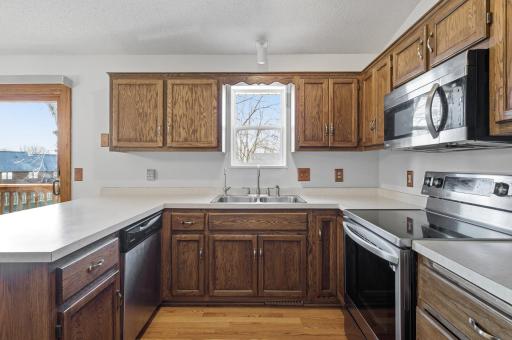 The kitchen features fantastic refinished cabinets, newer stainless steel appliances, and wood flooring.