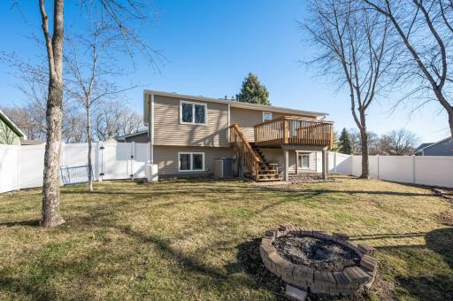 The backyard includes a full vinyl privacy fence, a built-in firepit, and a nice deck for relaxing or entertaining in the summer months.