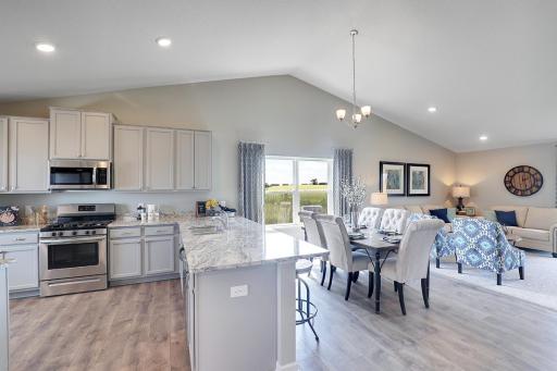 Open and expansive from end to end with magnificent, vaulted ceilings provide a seamless feel to an amazing open space. Photo of model home, finishes will vary.