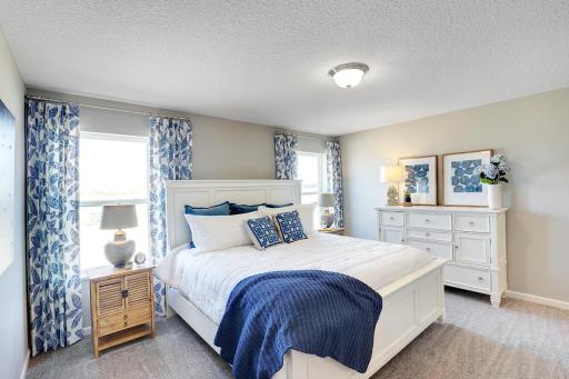 Spacious, imaginative and bright would best describe a primary suite that is an oasis of its own after a long hard day! Photo of model home, finishes will vary.
