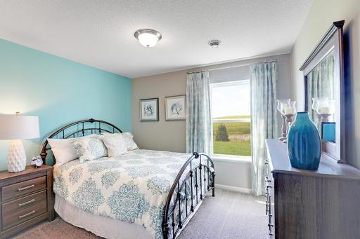 Space is also abundant in each of the home's secondary bedrooms - of which there are three in addition to the primary suite. Photo of model home, finishes will vary.