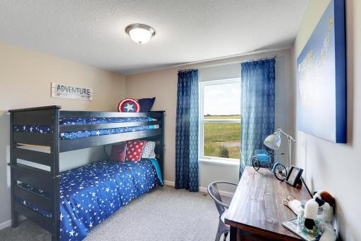 Space is also abundant in each of the home's secondary bedrooms - of which there are three in addition to the primary suite. Photo of model home, finishes will vary.