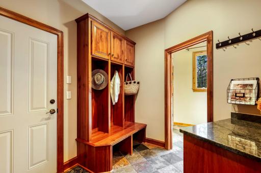 Mud room with lockers and large coat/storage closet.