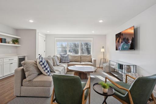 Upper level living room with wine fridge. Washer/dryer in closet.