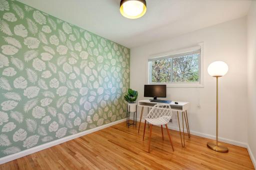 Custom painted botanical wall. Third bedroom upstairs, currently used as a home office with views of the backyard.