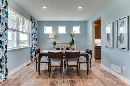 The formal dining room, connecting to the kitchen thru the butler's pantry adds a wonderful sophistication to this home. Example from model home.