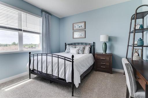The main level bedroom is great for guests, giving them some privacy or would be a great office or even yoga studio. Example from model home.
