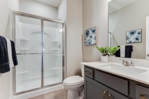 A view of the main level bathroom off of the bedroom. Example from model home.