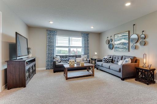 The upper level loft is a large as many family rooms, a great space to unwind, read books or watch t.v.'s. Example from model home.