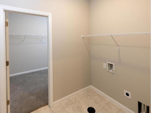 Laundry Room. Photo taken of another home with similar plan and finishes. Photos and renderings may not depict actual plan, materials, & finishes may vary. All measurements are approximate.