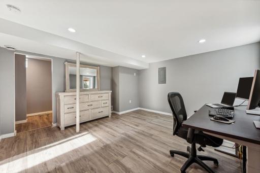 This lower-level 3rd bedroom with new luxury vinyl flooring, and 10'2 x 6'11 walk in closet. Can be used as an office or workout room.