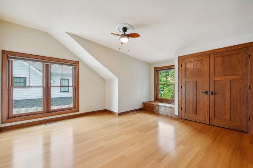 Upper level bedroom 3 with double door closet and built-in bench with storage drawers.