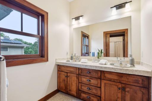 Upper level full bathroom with double sink vanity.