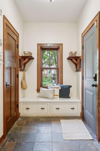 Mudroom with coat closet and built-in storage.