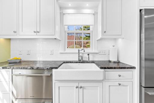 The gorgeous inset cabinets are a high end finish in a home at this attainable price point. The uppers go to the ceiling and are topped with crown moulding. The large apron sink can hold the largest of pots and pans and the window overlooks the yard.