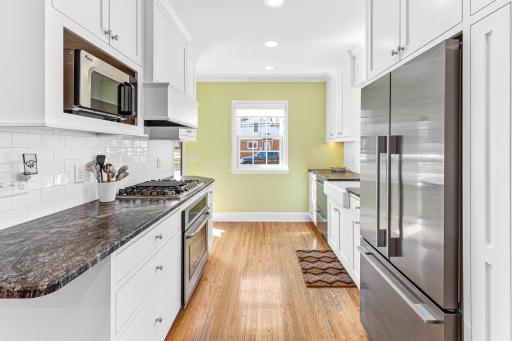 The kitchen was professionally remodeled in 2016 by Santanni Custom Homes and features impeccable craftsmanship and luxe details including leathered granite countertop, inset custom cabinets, 2 new Andersen Windows, apron front sink and more!